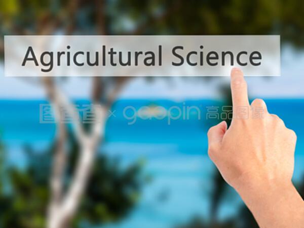 农业科学——手按下模糊背板上的按钮